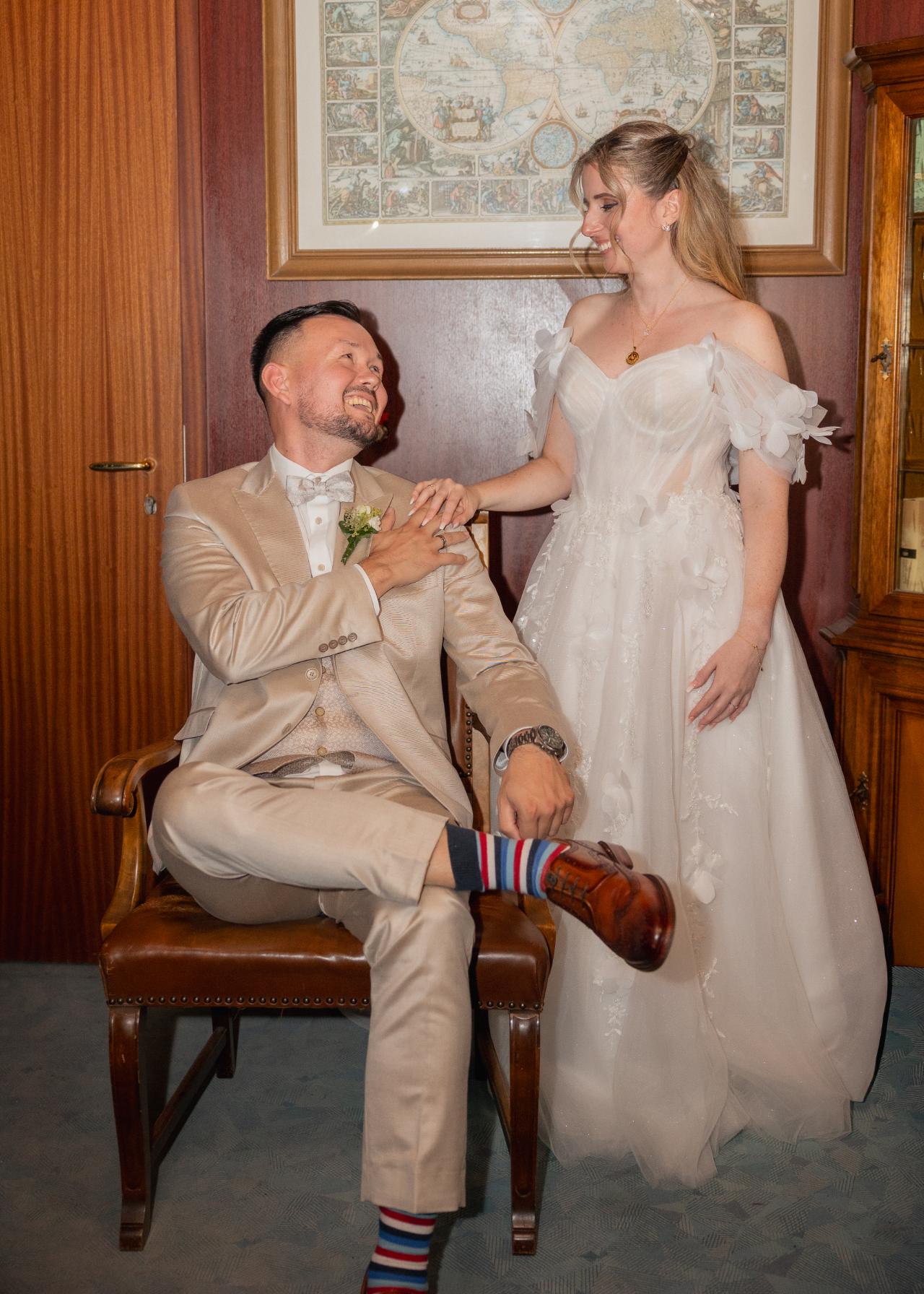 Bride and groom sharing a joyful moment during an indoor wedding portrait