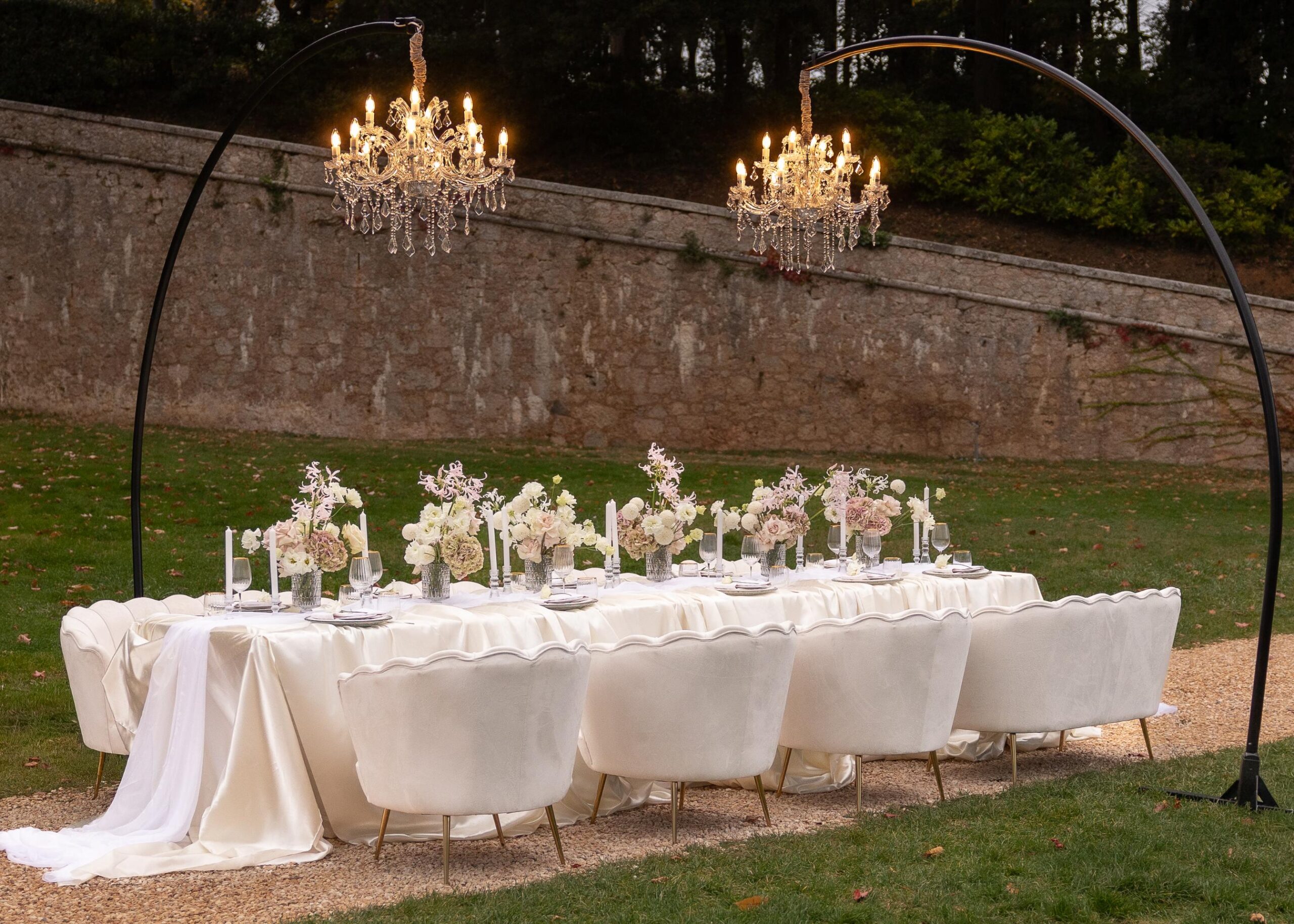 Elegant wedding table setting with pastel florals, candles, and fine glassware at an Italian villa outdoor reception.