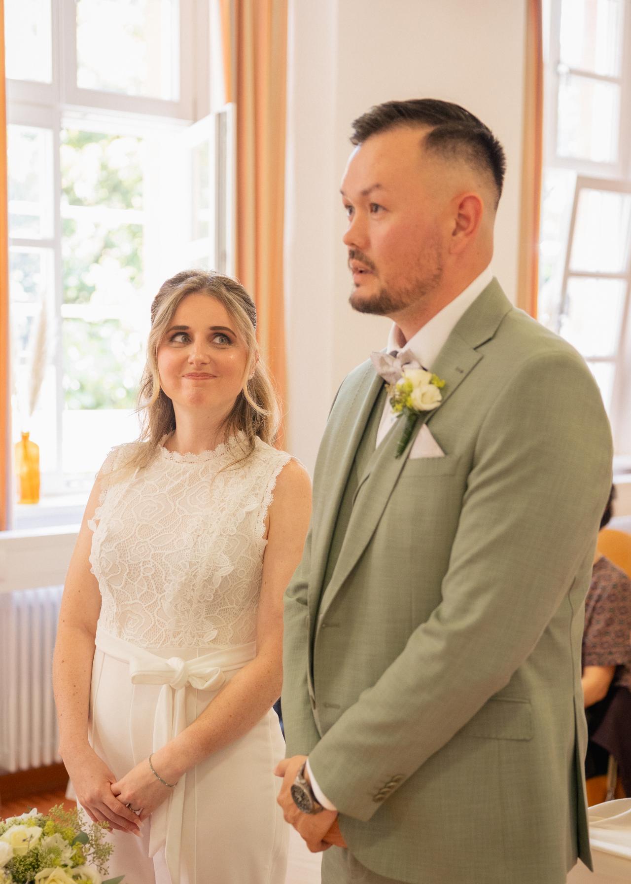 Bride and groom standing together during their civil wedding vows
