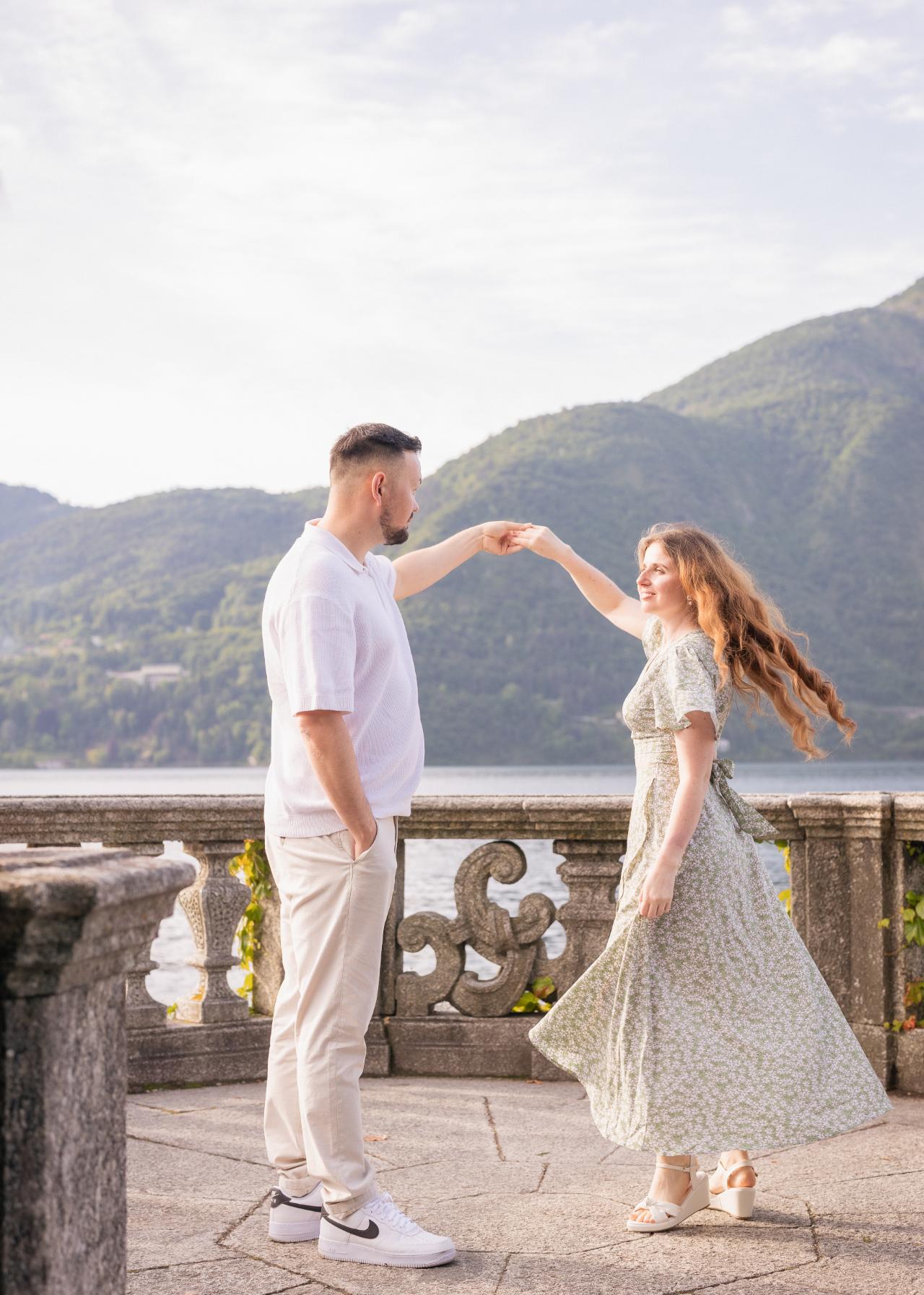 Engaged couple dancing on a villa terrace by Lake Como