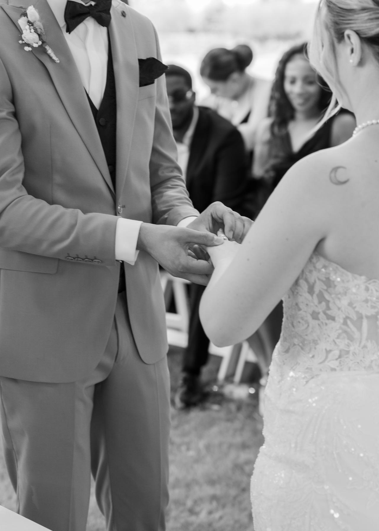 Groom placing the wedding ring on the bride’s finger during the ceremony
