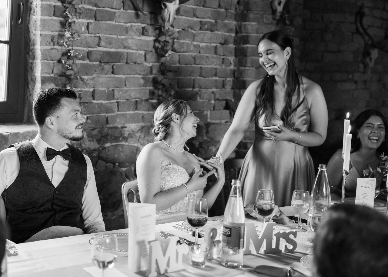 Bride laughing during an emotional wedding speech