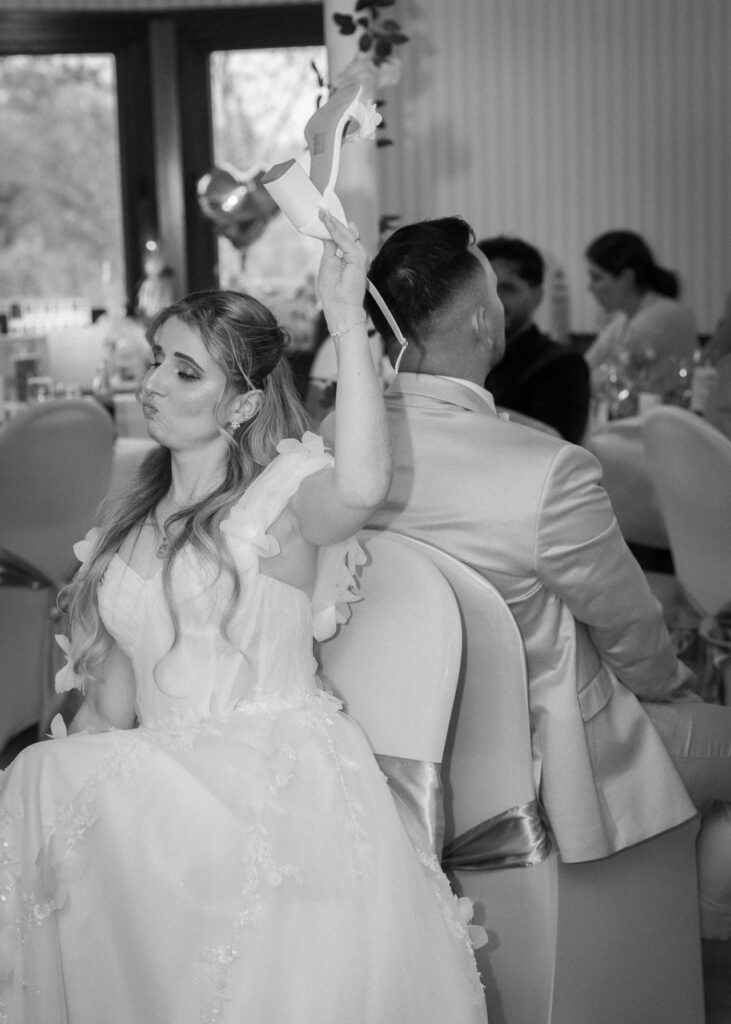 Bride and groom playing the shoe game during their wedding reception