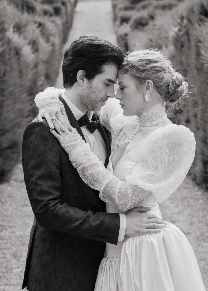 Intimate black and white portrait of a bride and groom embracing during a luxury wedding at Castello di Celsa, Tuscany.