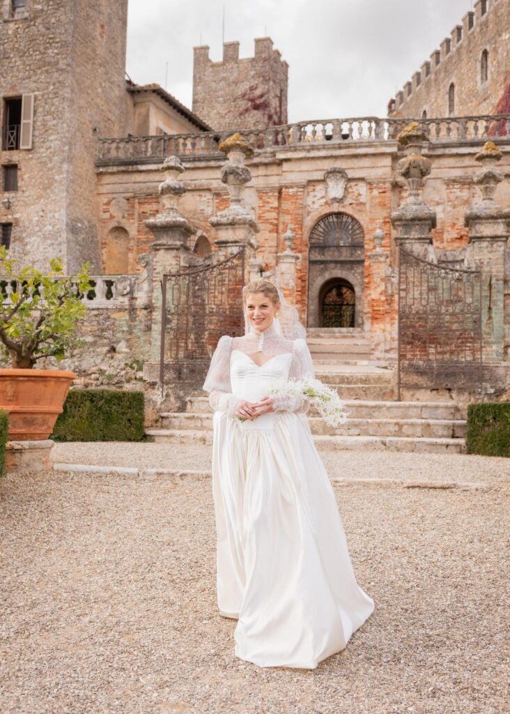 Bride in an elegant lace wedding dress at Castello di Celsa, Tuscany, during a luxury destination wedding in Italy.