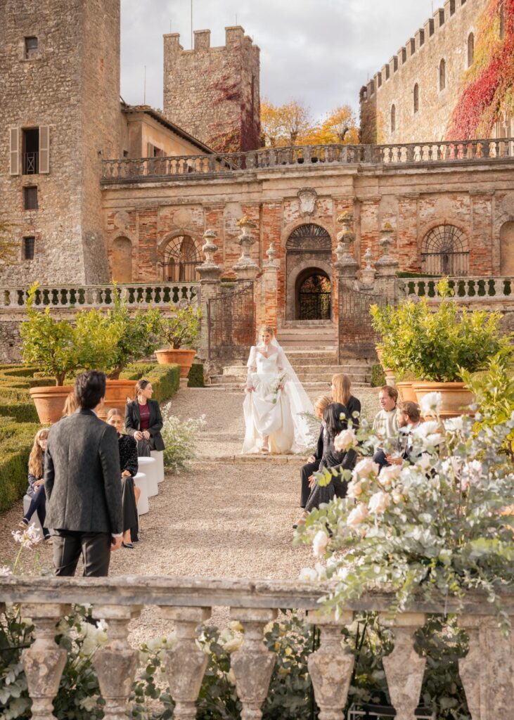 Bride walking down the aisle during an elegant wedding ceremony at Castello di Celsa in Tuscany
