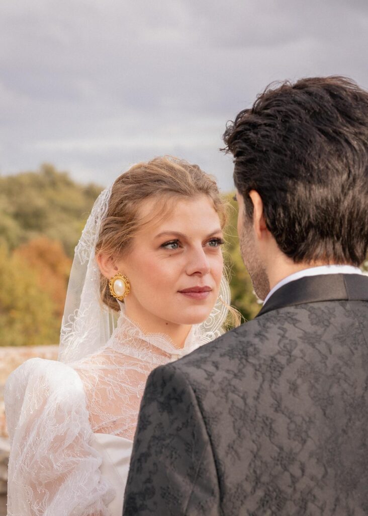 Intimate wedding ceremony moment as the bride looks at the groom during a romantic Italian villa wedding with countryside views.